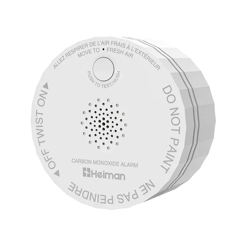 Round white Heiman C1-M CO alarm with a front test button and perforated sounder