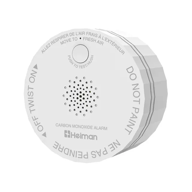 Round white Heiman C1-M CO alarm with a front test button and perforated sounder