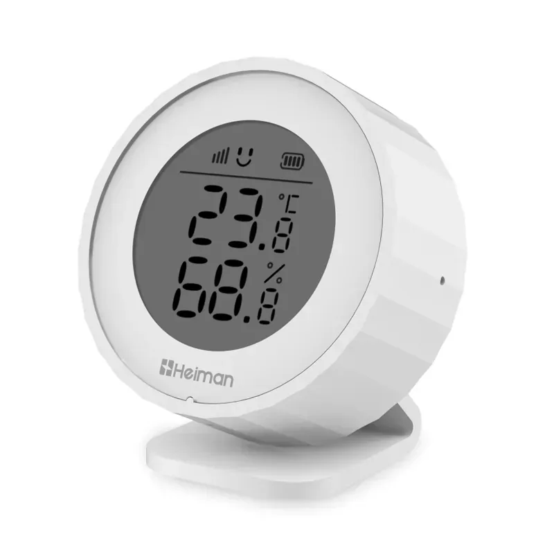 Round white Heiman H1-M showing temperature and humidity on its LCD, resting on a small stand