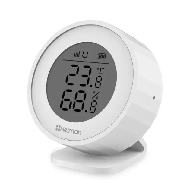 Round white Heiman H1-M showing temperature and humidity on its LCD, resting on a small stand