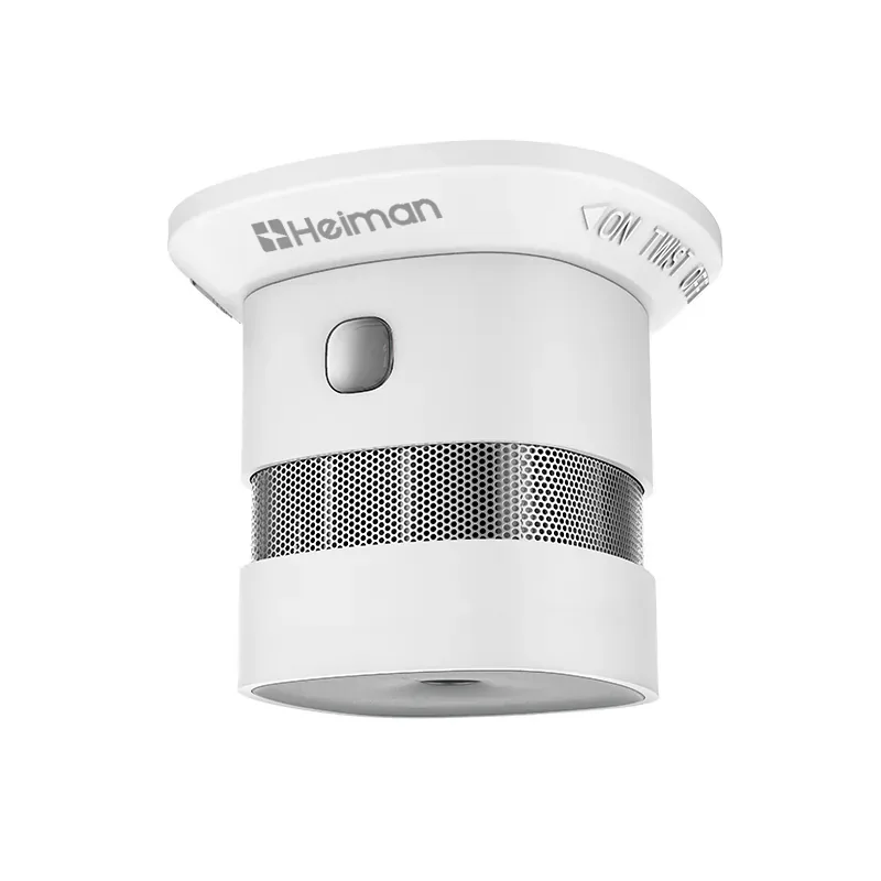 Small cylindrical Heiman HS1SA-M smoke alarm with a mesh band around its body